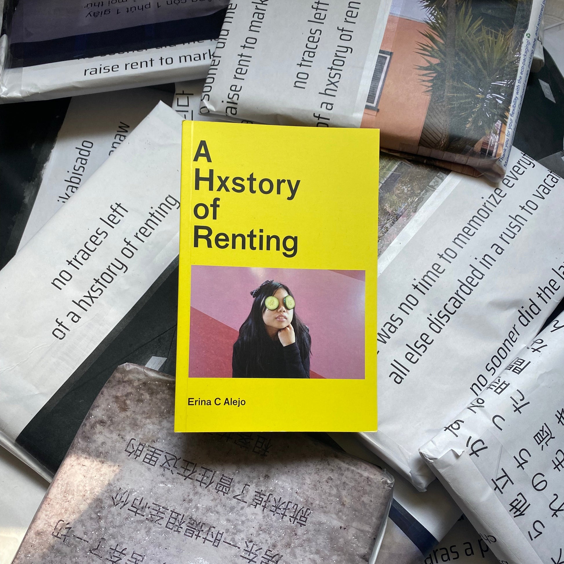 Book titled 'A History of Renting' with a yellow cover on a textured surface.